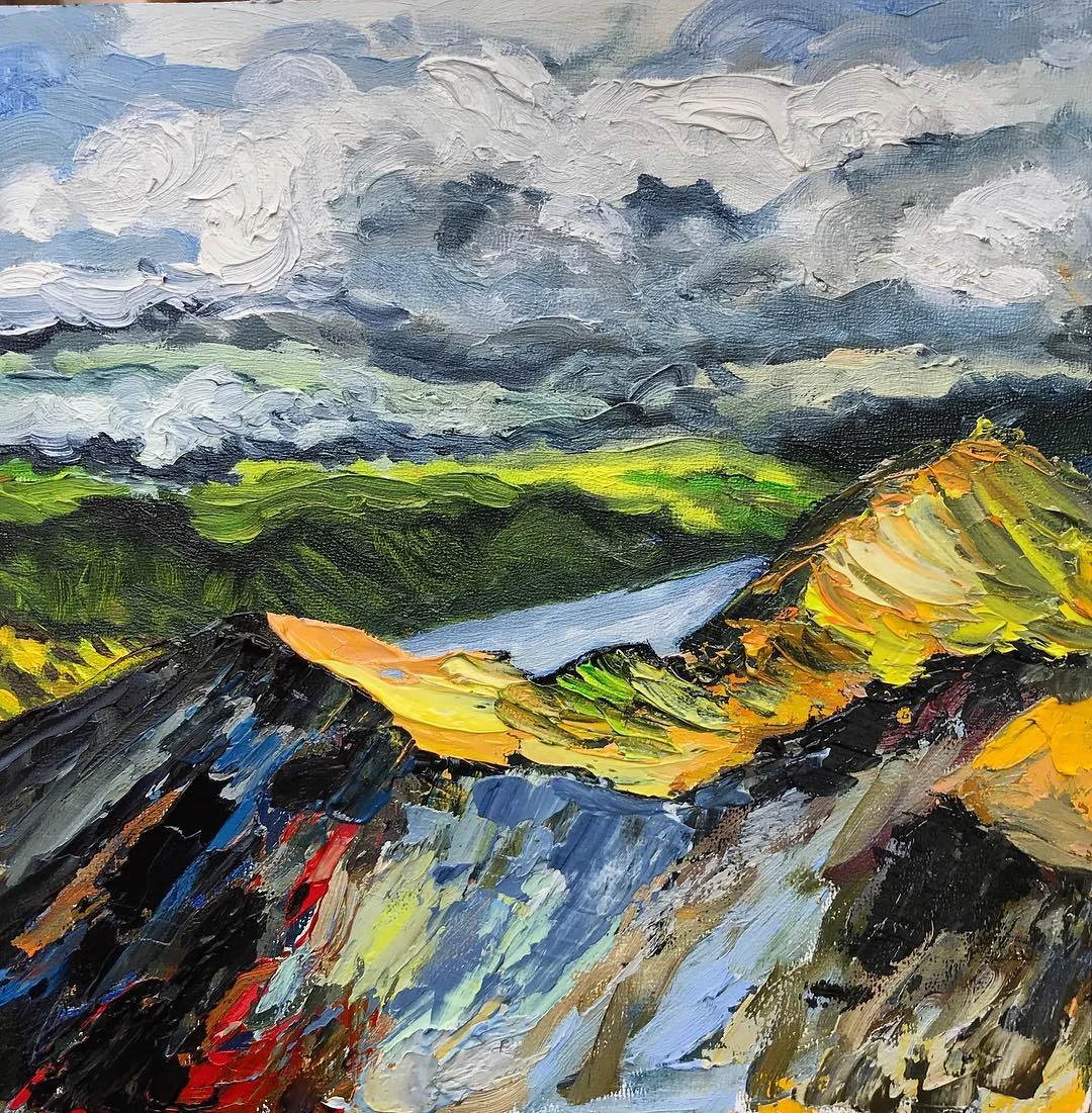 Mountain valley under layered storm clouds